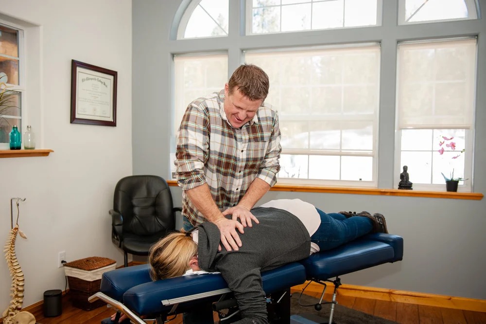 Dr. Jason Casto working on a patient's back in the South Lake Tahoe office