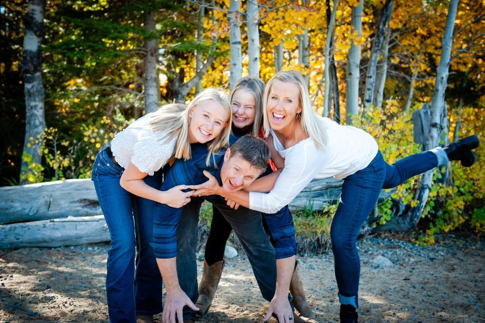 Dr. Nichole and Dr. Jason Casto with their family outdoors in the fall